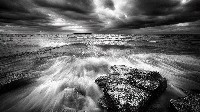 Brooding Stormy Seascape with Crashing Waves Wallpaper
