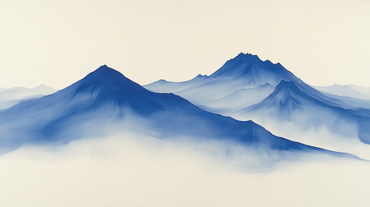 Blue mountain range with misty horizon in a serene setting.