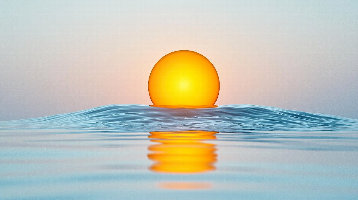 A bright yellow sun rising over calm blue ocean waves.